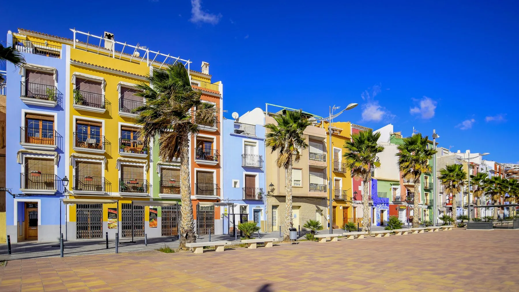 Colourful Costa Blanca homes beneath a clear blue sky